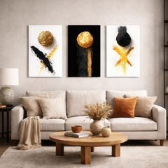 Black and gold abstract triptych wall art displayed above sofa in neutral living room — modern metal wall decor.