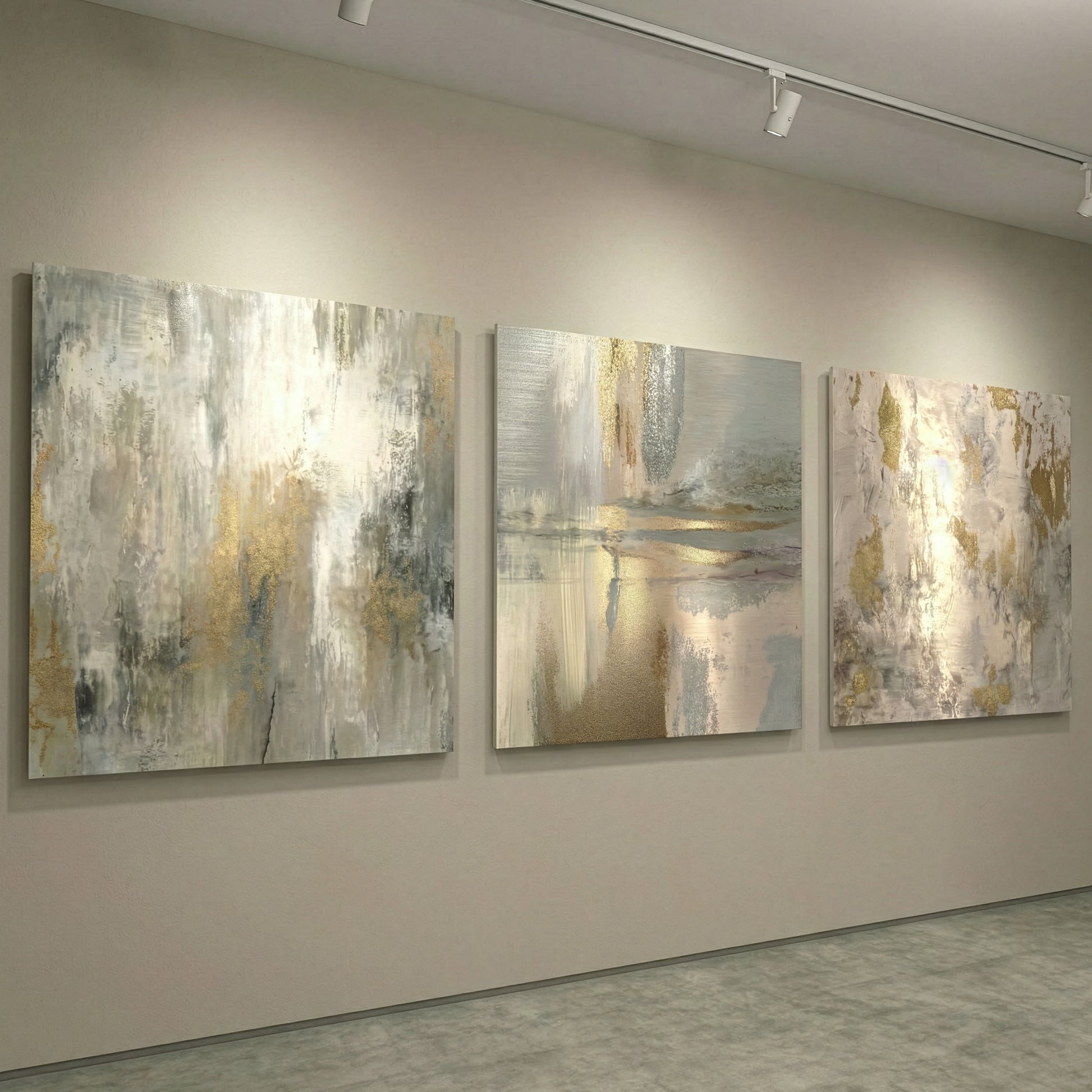 Three abstract paintings on a wall in a gallery setting