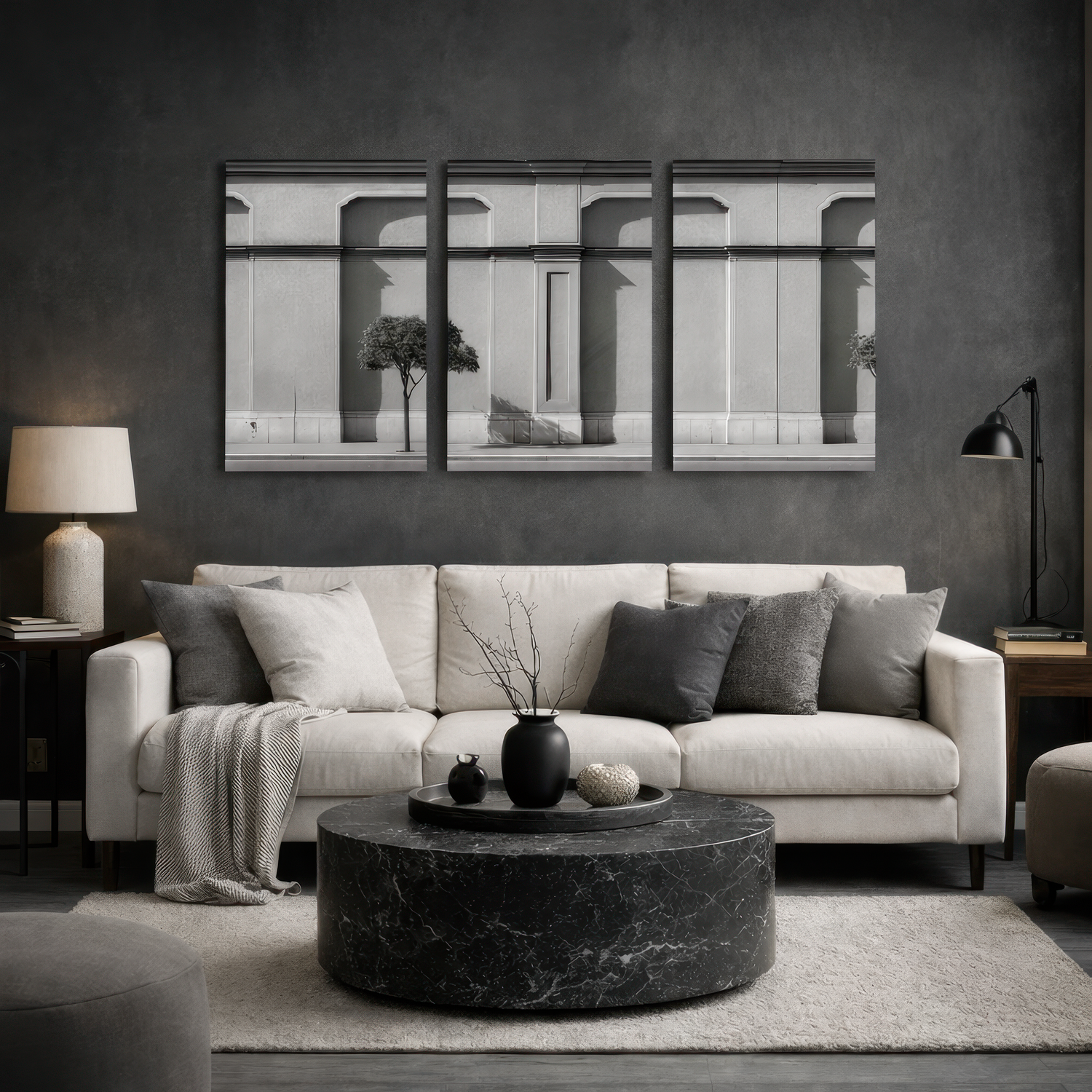 Three panel black and white classical facade wall art displayed above neutral sofa in modern dark living room interior