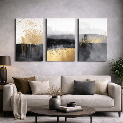 Gold, grey and black abstract triptych canvas art above sofa in a modern living room — stylish decorative wall art.