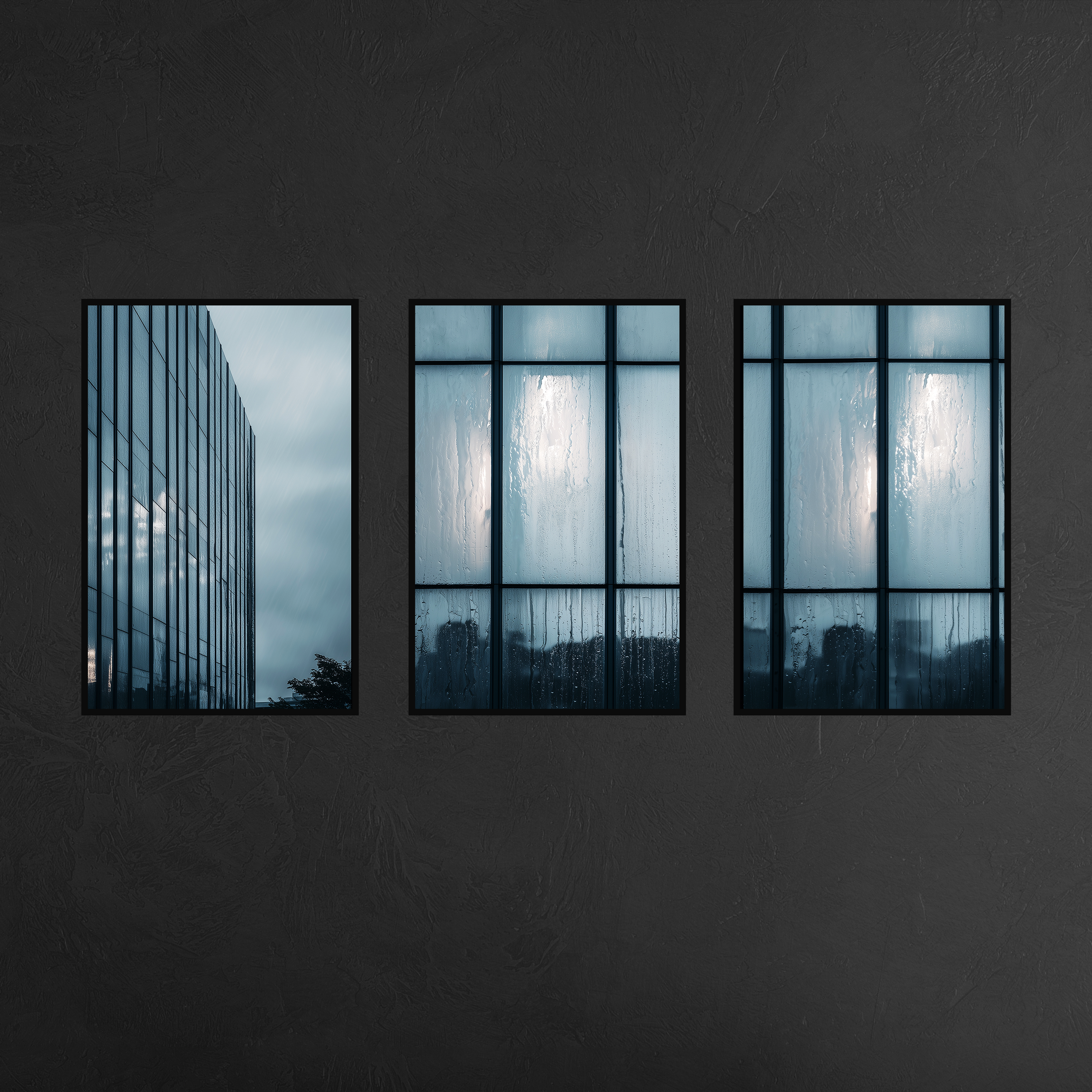 Three panel urban architecture wall art with slim black metal frames mounted on charcoal textured wall, featuring reflective skyscraper and rain soaked windows