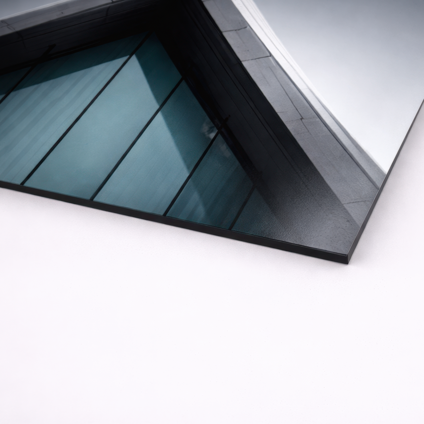 Close up angled view of smooth non brushed aluminum wall art print showing thin edge profile and architectural glass reflection texture