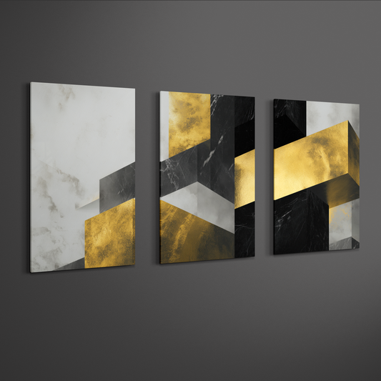 Angled view of black, white and gold geometric abstract triptych canvas art on neutral wall — contemporary décor piece.