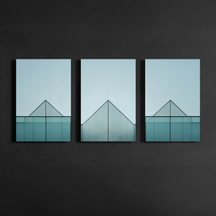 Three panel minimalist glass architecture artwork with triangular apex geometry displayed on dark textured wall with slim black frames