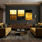 Gold and black abstract vertical triptych wall art displayed above console in modern living room — contemporary canvas décor.