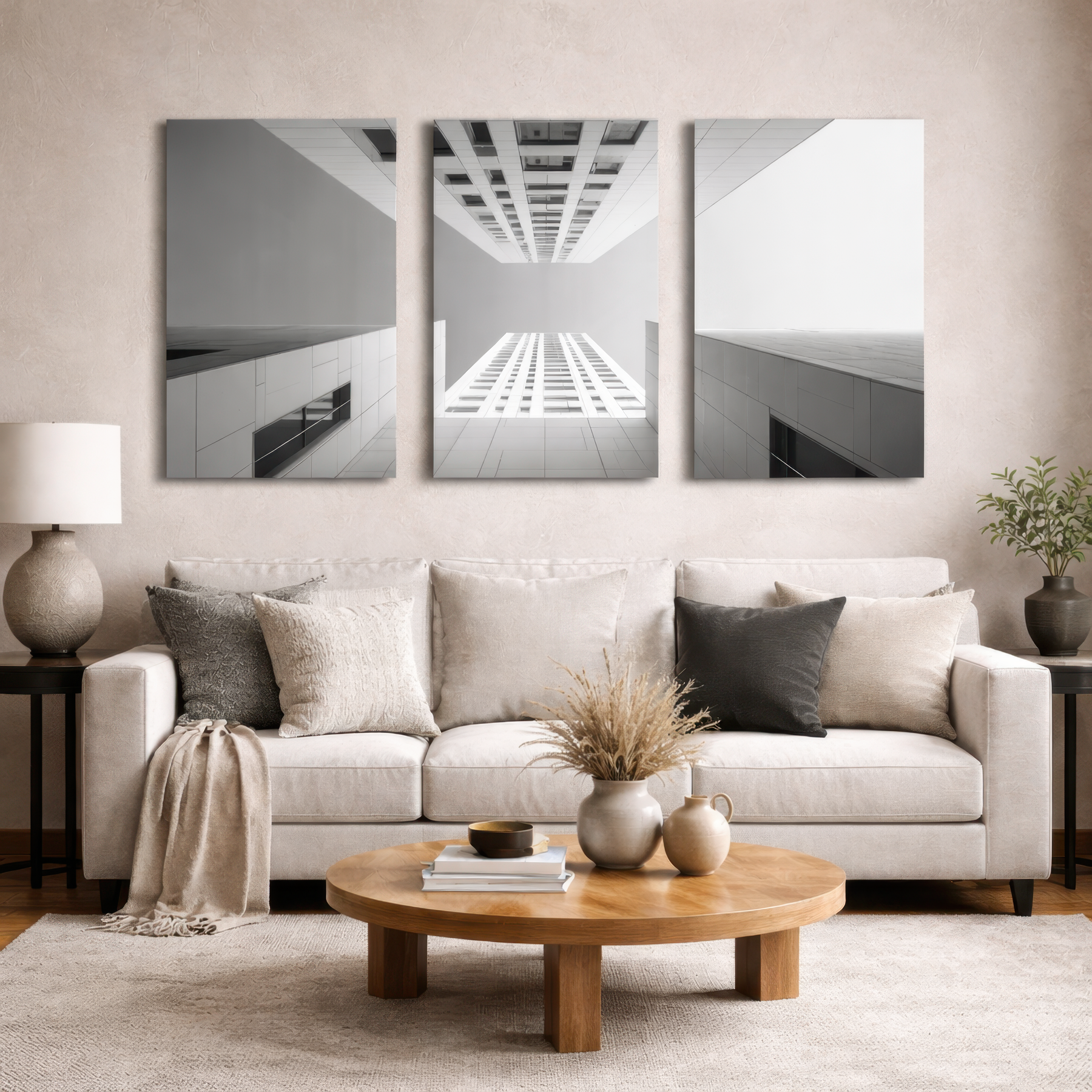 Three panel black and white building photography wall art above neutral sofa in modern living room, museum quality aluminum print for elegant home decor