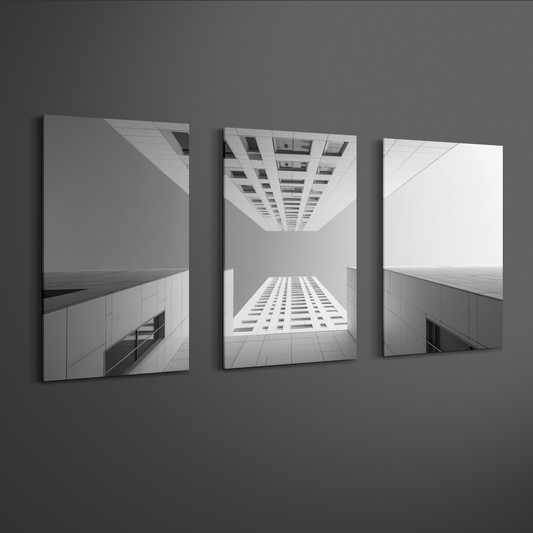 Wide angle view of three panel architectural photography wall art in grayscale, mounted on neutral wall with floating gallery effect for modern interiors