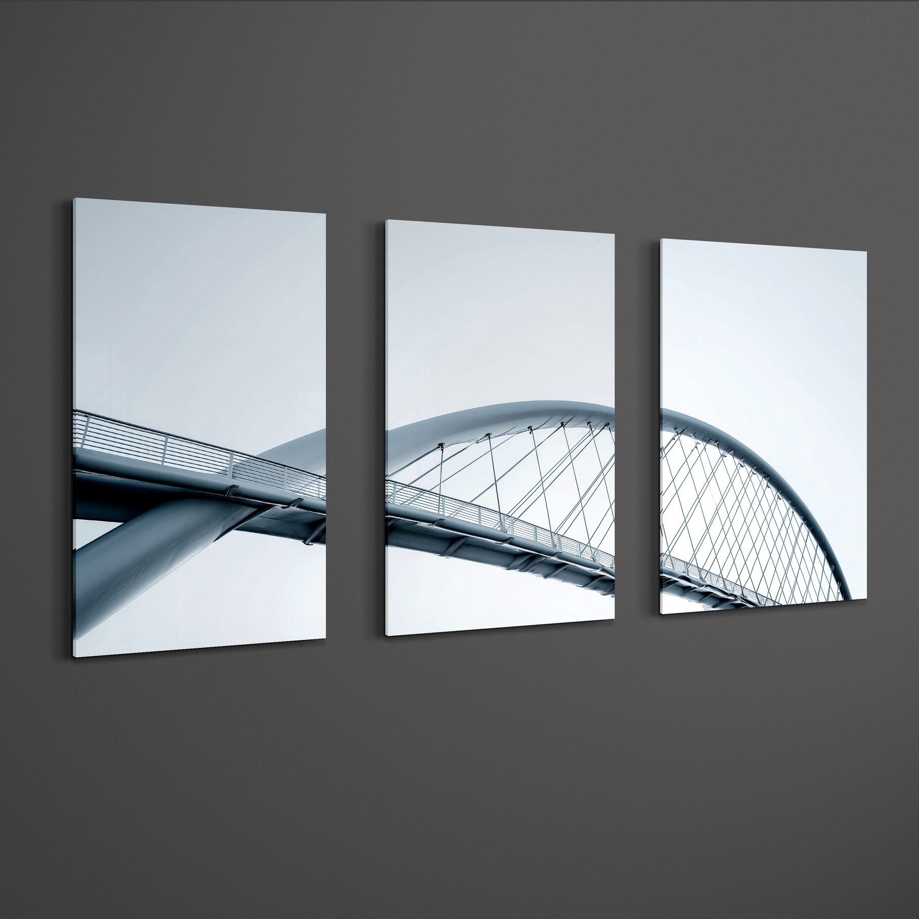 Angled perspective of three panel bridge photography wall art printed on smooth aluminum, balanced spacing on dark wall creating clean architectural focal point