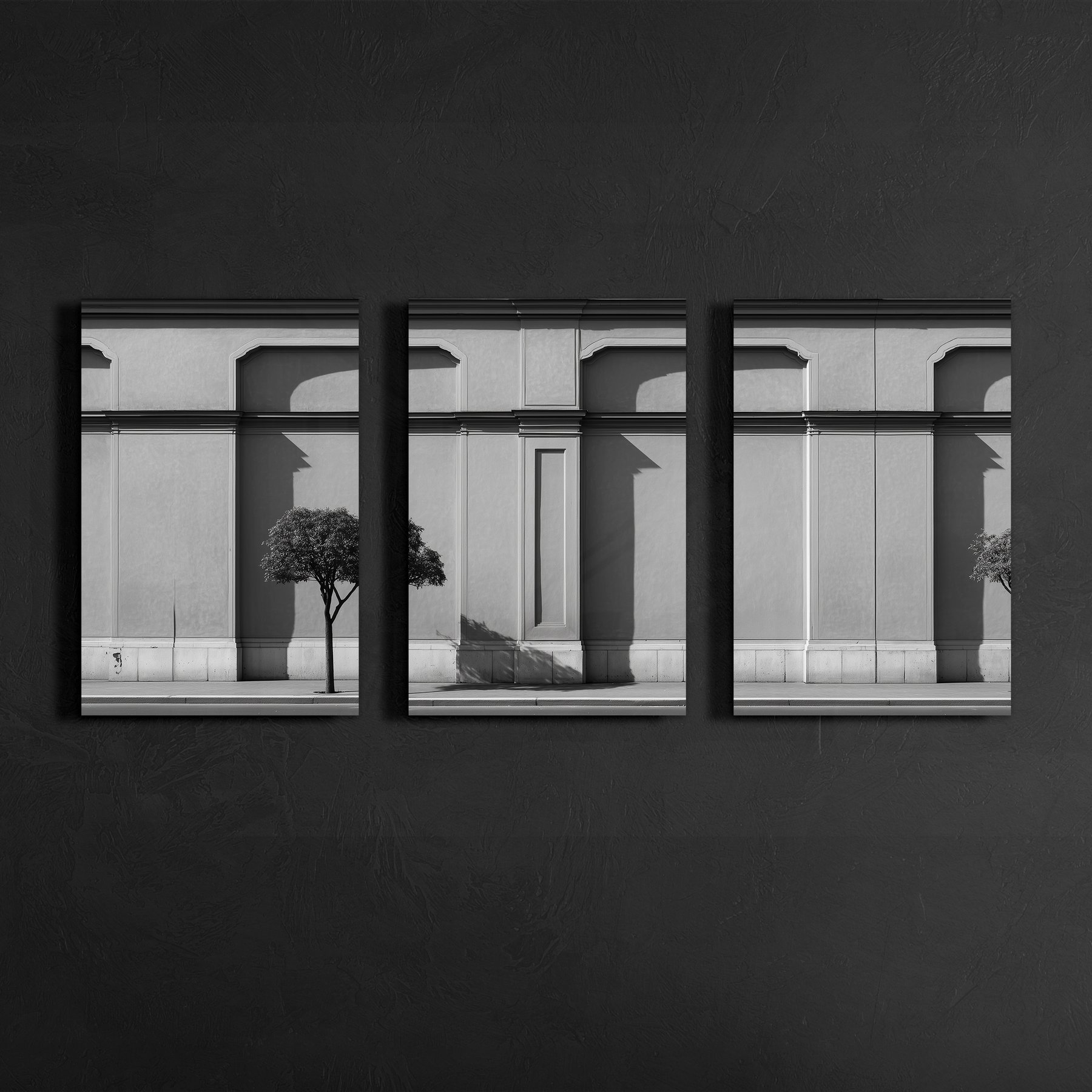 Front view of three panel black and white classical facade wall art mounted on dark textured wall, clean lines and balanced symmetry