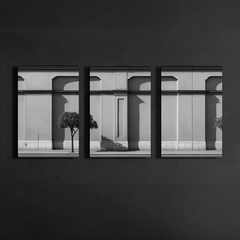 Front view of three panel black and white classical facade wall art mounted on dark textured wall, clean lines and balanced symmetry