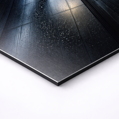 Close-up angled view of non brushed aluminum wall art showing rain droplets on modern glass facade, sharp edges and slim 3mm profile visible