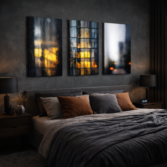 Three panel urban reflection wall art with golden city lights behind rain covered glass, displayed above modern bed in dark luxury bedroom interior